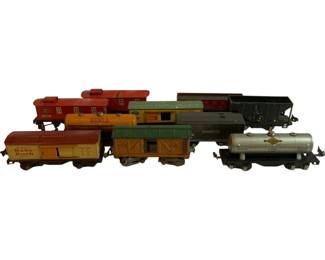 1173 - 10pc O Scale Toy Train Cars Lot 3"x8.5"x2" (Description): Collection of 10 O scale toy train cars featuring a variety of freight and tanker cars. The lot includes branded cars such as a Baby Ruth boxcar, Shell tanker, and Sunoco Motor Oil tanker, along with assorted cabooses, hoppers, and stock cars in various colors including red, yellow, green, gray, and silver. Each car measures approximately 3 inches by 8.5 inches by 2 inches. The cars display vintage painted tin construction