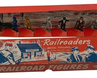 847 - Lincoln Logs The Railroaders Metal Figures (Description): Lincoln Logs 'The Railroaders' metal figures in original box. The set includes painted metal figures depicting various railroad passengers and personnel in mid-century attire. The colorful red box features illustrated railroad scenes and is marked 'Super Railroad Figures' with 'Metal Figures by Lincoln Logs' branding. The figures are hand-painted in various colors representing travelers and station workers. Box shows