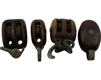 1196 - 4pc Antique Wood & Iron Ship Pulleys 4.5" (Description): Collection of four antique pulleys measuring 4.5 inches. These maritime block and tackle pulleys feature dark stained wooden shells with iron hardware including hooks and shackles. The set includes both double and single sheave designs, displaying rich patina consistent with age and use. Each pulley retains its original iron fittings and mechanisms.