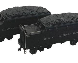 895 - 2pc Lot Lionel Coal Cars HO Scale 2"x9"x1" (Description): Two-piece lot of Lionel HO scale coal cars. Each tender car is finished in black and lettered for New York Central, with simulated coal loads in the bins. The cars feature ladder details and coupling hardware. Measures 2" x 9" x 1".