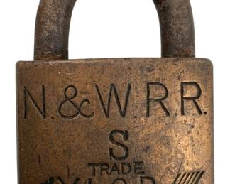 665 - Norfolk & Western Railroad trade padlock (Description): Norfolk & Western Railroad trade padlock without key. The brass padlock features the N.&W.R.R. marking along with the XLCR trademark with arrow design. Measures 2 3/4 inches by 2 inches.