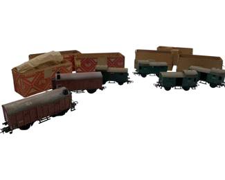 305 - Group Lot of 6 Marklin Train Cars 2"x2"x4" (Description): A group lot of six Marklin train cars. The collection includes both brown and green colored freight cars with their original boxes. Each car measures approximately 2" x 2" x 4".