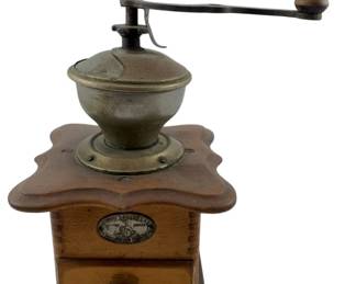 94 - Vintage Helios Coffee Grinder 10"x5.5"x5.5" (Description): Vintage Helios coffee grinder featuring a wooden box base with a pull-out drawer for collecting grounds. The grinder has a metal hopper with a hand crank mechanism topped with a wooden knob. The body displays a scalloped wooden top plate and bears the Helios maker's label on the front. Measures 10 inches tall by 5.5 inches wide by 5.5 inches deep. Used as is electric/electronic/mechanical
