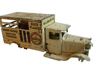 1072 - Antique Metal Truck - #3 4.5"x12"x3.5" (Description): Antique metal truck featuring vintage H.J. Heinz Co. advertising. The truck displays Heinz 57 Varieties branding along with text reading "Pure Food Products," "Rice Flakes," "Baked Beans," and "Bottled Vinegars." The piece shows age-appropriate wear consistent with its antique status. Measures 4.5" x 12" x 3.5".