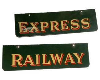 822 - 2pc Express Railway Porcelain Metal Sign Set (Description): Two-piece porcelain metal sign set reading "Express" and "Railway." The signs feature dark green backgrounds with gold lettering accented by red shadowing, creating a classic vintage railway aesthetic. Each sign has mounting holes at the top and bottom. Signs measure 20" x 6".