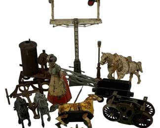 1191 - Lot Antique Cast Iron & Tin Toys (Description): A collection of antique toys including cast iron and tin pieces. The lot features several horse figures including a white horse with cart, a painted carousel-style horse on a rocker base, and gray cast iron horse figures. Also included is a painted tin figure of a woman in traditional dress with red skirt, a painted tin railroad signal or semaphore, cast iron wagon wheels and cart components, a cylindrical form, and various