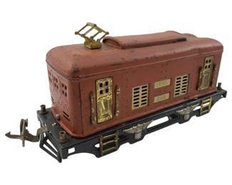340 - Antique Lionel "O" Gauge Caboose 3"x9"x2" (Description): Antique Lionel "O" Gauge caboose in a distinctive red-orange painted finish. This vintage model train car features gold-tone trim and detailing. Measures 3 inches high by 9 inches long by 2 inches wide.
