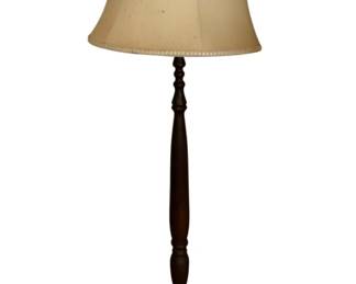 172 - Vintage Turned Wood Floor Lamp w/ Shade (Description): Vintage wood floor lamp featuring a turned wooden base with a dark finish and circular foot. The lamp is fitted with a cream-colored fabric shade with decorative trim along the top and bottom edges. Note: missing glass shade. Measures 56 inches tall. Used as is electric/electronic/mechanical item. No guarantee all components, untested.
