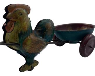 296 - Vtg Tin Litho Rooster w/ Wagon Pull Toy (Description): Vintage tin lithograph rooster with wagon pull toy. This charming piece features a colorfully painted rooster in shades of green, yellow, and brown with a red comb and wattle, attached to a small wheeled cart or wagon. The toy shows desirable age-appropriate wear consistent with its vintage status. Measures 4 inches by 3 inches by 8 inches.