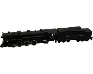 1148 - Lionel HO Scale Locomotive & Coal Car (Description): Lionel HO Scale locomotive and coal car set. The black steam locomotive is numbered 443 and features detailed wheel configuration. The accompanying tender car is marked "New York Central" and styled as a coal car. Measures 3 inches high by 13 inch long by 2 inches wide.