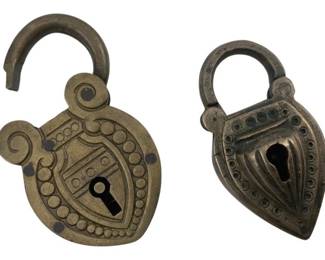 683 - Group of 2 Padlocks w/o Keys 2"x1" (Description): Group of two decorative padlocks without keys. Both feature ornate designs with beaded borders and shield-shaped bodies with curved shackles. Measures 2 inches by 1 inch.