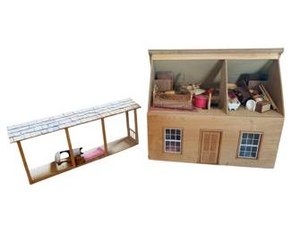 36 - Playtoys Doll House w/ Contents 20x24x20.5" (Description): Playtoys wooden doll house with contents, measuring 20" x 24" x 20.5". This charming two-story dollhouse features a natural wood exterior with double doors, paned windows, and an open back for play access. The interior is furnished with an assortmt of miniature furniture and accessories including wicker pieces, beds, chairs, and decorative items. Also included is a matching wooden stable or barn structure with a shingled roof