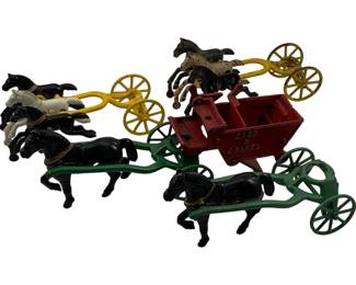 1085 - Lot Cast Iron Horse & Buggy Toys As Is (Description): The collection includes multiple horse-drawn vehicles with colorful painted finishes in yellow, green, and red, along with various black and white horse figures with painted gold harness details. One wagon features 'Sand & Gravel' text on its red body. Parts can be assembled into different horse and buggy configurations.