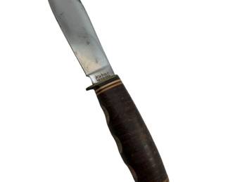 731 - Kabar 1205 USA Knife 10" (Description): Kabar 1205 USA knife featuring a stacked leather handle with aluminum pommel and guard. The blade is marked "Kabar 1205 USA." Measures 10 inches in overall length.
