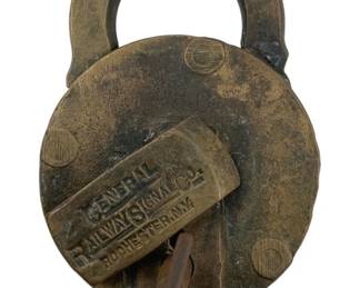 600 - General Railway Signal Co Padlock w/Key 3"x2" (Description): Antique General Railway Signal Co. padlock with original key, marked Rochester, N.Y. This brass railroad padlock features a circular body with a rounded shackle and shows a well-aged patina consistent with its age and use. The key is embossed with the company name. Measures 3" x 2".