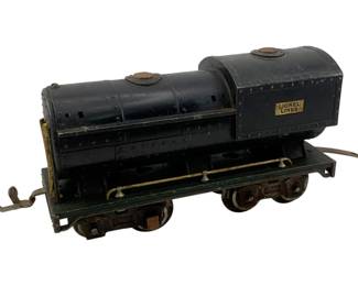 961 - Lionel O Scale Locomotive 4.5"x10"x2.5" (Description): Lionel O Scale locomotive featuring classic Lionel Lines branding. This vintage model train measures 4.5 inches high by 10 inches long by 2.5 inches wide.