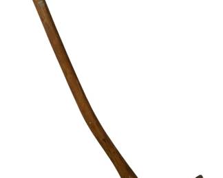 819 - Antique Hoe Axe Tool 32" (Description): Antique combination hoe axe tool featuring a forged iron head with dual functionality — a broad hoe blade on one side and an axe blade on the opposite. The head is mounted on a curved wooden handle showing natural grain and age-appropriate wear. This versatile agricultural implement was commonly used for clearing brush, grubbing roots, and preparing soil. Measures 32 inches in length.