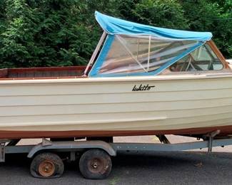 1250 - Vintage Wooden Lapstrake Boat (Description): This Vessel features a Classic White Hull with a wood toned lower section and includes a blue canvas canopy over the cockpit, mounted on a trailer w/ twin vintage Evinrude outboard motors. Used as is electric/electronic/mechanical item. No guarantee all components, untested.