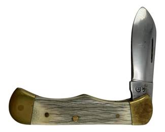 732 - R&M Pocket Knife 3.75"x1.25" (Description): R&M pocket knife featuring a folding blade design with brass bolsters and rivets. The handle displays a textured bone or antler material with natural striations. Measures 3 3/4 inches by 1.25 inches when closed.