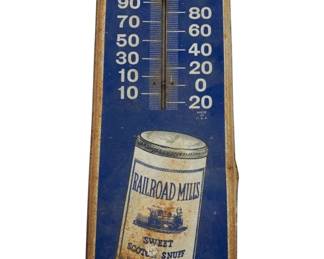 409 - Vtg Railroad Mills Snuff Advertising Therm. (Description): Vintage Railroad Mills Sweet Scotch Snuff metal advertising thermometer. This blue painted tin sign features a depiction of the iconic snuff canister with locomotive imagery and reads "Smokeless Treat" at the bottom. Marked "Made in U.S.A." The thermometer displays temperature in Fahrenheit. Shows age-appropriate wear with rust along the edges and some surface patina. Measures 16" x 6".