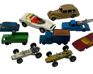 869 - 9pc Lot Die-Cast Cars Matchbox Dinky & Misc (Description): A collection of nine die-cast toy cars including Matchbox, Dinky, and miscellaneous brands. The lot features a variety of vehicle types including sports cars, trucks, racing cars, and vintage automobiles in assorted colors such as blue, white, green, maroon, and tan. The collection displays various play-worn conditions typical of vintage die-cast toys.