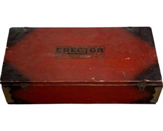 1227 - Vtg Erector Set in Red Wood Box 6"x29"x10.5" (Description): Vintage Erector Set housed in its original red-painted wooden storage box. The box features brass corner hardware and latches, with the Erector branding visible on the lid. The painted finish shows authentic age-related wear and patina consistent with decades of use. Measures 6" x 29" x 10.5".