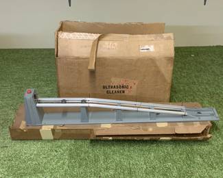 1146 - Train Component & Ultrasonic Cleaner in Box (Description): A lot of what appears to be a gray model train platform or track component with metal rails. The lot also includes a nultrasonic cleaner in box.