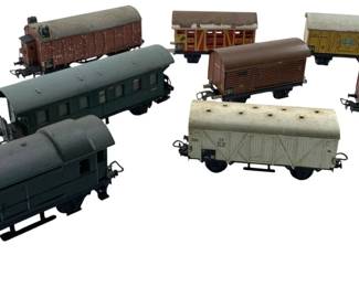 302 - Group Lot of 8 Marklin Train Cars 2"x2"x6" (Description): Group lot of 8 Marklin train cars. The collection includes various styles of rolling stock. Each car measures approximately 2" x 2" x 6".