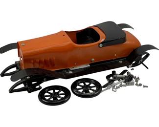 968 - Vtg Metal Mechanical Car Model Kit (Description): Vintage metal mechanical car model kit. The kit includes the car body, chassis components, wheels, axle, and assorted hardware for assembly. Measures 5" x 16" x 16".
