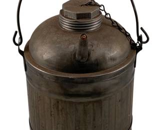 977 - Metal Oil Can 10.5"x8.25"x7.5" (Description): Vintage metal oil can featuring a ribbed body, bail handle, spout, and screw-top cap with attached chain. Measures 10.5 inches by 8.25 inches by 7.5 inches.
