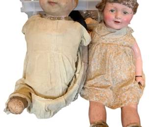 171 - Group Lot w/ Antique Composition Dolls & More (Description): A group lot featuring antique dolls and additional items. The lot includes two vintage composition dolls with painted features and molded hair, dressed in period cotton dresses. One doll wears a cream-colored dress while the other is dressed in a peach floral print frock with green shoes. Additional items are included in the lot.