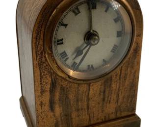 723 - Antique Brass Desk Clock 5"x3.25"x2.5" (Description): Antique brass desk clock featuring a classic arched case design with Roman numeral dial. Measures 5" x 3.25" x 2.5". Used as is electric/electronic/mechanical item. No guarantee all components, untested.