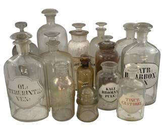 521 - Lot Apothecary Glass Bottles 12" (Description): A lot of glass bottles. The tallest bottle measures 12 inches in height.