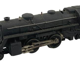 828 - Lionel #204 Locomotive O Scale 3.5"x9"x2.5" (Description): Lionel #204 locomotive in O scale. This black die-cast steam engine features a classic 2-4-2 wheel configuration with silver metal running gear and side rods. The cab displays the number 204 on the side. The locomotive measures 3.5 inches high by 9 inches long by 2.5 inches wide.