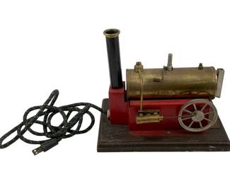 938 - Weeden Electric Engine 8"x9"x6" (Description): Weeden electric engine mounted on a wooden base. This vintage toy steam engine features a brass boiler, flywheel, and original electrical cord. Measures 8 inches by 9 inches by 6 inches. Used as is electric/electronic/mechanical item. No guarantee all components, untested.