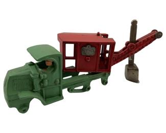 722 - Hubley Cast Iron Mack Steam Shovel Truck (Description): Vintage Hubley cast iron Mack "General" steam shovel truck. This collectible toy features the classic Mack truck cab with an attached steam shovel mechanism. The piece is missing its wheels. Measures 4 inches high by 10 inches long by 4.25 inches wide.