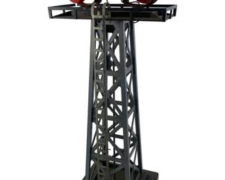 223 - Vtg Model Train Rotating Beacon Tower (Description): Vintage model train rotating beacon or floodlight tower. This accessory piece features a lattice-style tower structure with a platform supporting dual rotating beacon lights. Measures 13" x 5" x 5".