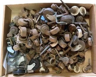 481 - Box Lot of Antique Wood & Cast Iron Wheels (Description): A box lot of antique wood and cast iron wheels. This collection includes various styles of casters and wheels suitable for furniture restoration or decorative purposes.