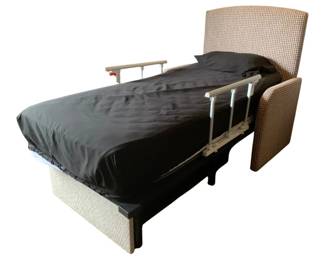 164 - Twin Bed w/Bedding & Side Rails 51"x86"x47" (Description): Twin bed with bedding and side rails. The bed features an upholstered woven fabric headboard in a neutral tan tone with matching side panels. Includes bedding. Safety side rails are attached on both sides of the bed. The bed sits on a low platform base. Measures 51" x 86" x 47".