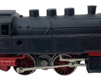 257 - Marklin Train Engine 2"x52" (Description): Marklin train engine featuring classic black and red coloring with detailed wheel assembly and coupling mechanism. Measures 2 inches by 52 inches.