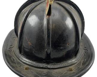 657 - Firemans Helmet Cairns & Brothers 7"x16"x11" (Description): Fireman's helmet manufactured by Cairns & Brothers. This traditional firefighter helmet features a classic design with a protective brim. Measures 7 inches by 16 inches by 11 inches.