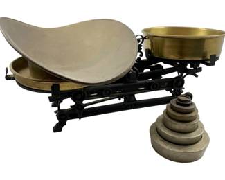 105 - European Cast Iron Balance Scale Brass Pans (Description): Vintage European cast iron balance scale featuring brass pans and a set of nested weights. The scale has a black painted cast iron frame with decorative scrollwork, a large scoop pan on one side and a round brass bowl on the other. Includes a graduated set of stacking weights. Capacity of 3 kilograms. Measures 6 inches by 16 inches by 6 inches. Used as is electric/electronic/mechanical item. No guarantee all components, untested.