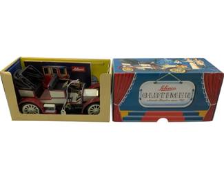 1178 - Schuco Oldtimer 1902 Mercedes Simplex in Box (Description): Schuco Oldtimer 1902 Mercedes Simplex model car in original box. This vintage tinplate toy features a detailed reproduction of the classic early automobile with red and white body, black seats, and gold-tone accents. The car comes in its original decorative display box featuring theatrical curtain graphics and period-style illustrations. Made in Germany.