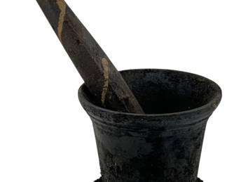1017 - Cast Iron Mortar & Pestle 9"x5" (Description): Cast iron mortar and pestle set. The mortar measures 9 inches by 5 inches. A classic utilitarian piece showing its age and use, suitable for grinding herbs, spices, or other materials.