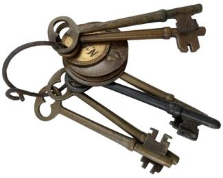 653 - Set of Antique Skeleton Keys on Ring 3.5" (Description): A set of antique skeleton keys gathered on a ring. The collection features various sizes and styles of vintage keys, showcasing different bit patterns and bow designs typical of period hardware. Measures 3.5 inches.