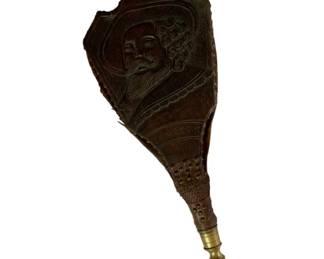 44 - Wood, Leather & Brass Fireplace Bellows (Description): Antique wood, leather, and brass fireplace bellows featuring carved decorative panels with a portrait of a bearded gentleman wearing a hat. The wooden boards display intricate hand-carved detailing, while the brass nozzle provides a traditional finishing touch. The bellows show age-appropriate wear consistent with period use. Measures 26 1/2" x 9".