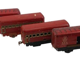 886 - 4pc Lot Marx Tin Litho Train Cars 3"x6"x1.5" (Description): Four-piece lot of Marx tin lithograph train cars featuring red painted finishes. The set includes two Pullman passenger cars, one B&LE boxcar numbered 90171, and one Baltimore & Ohio (B&O) boxcar numbered 554295. Each car displays typical Marx tin lithograph detailing with window cutouts and railroad company markings. Cars measure 3 inches by 6 inches by 1.5 inches.