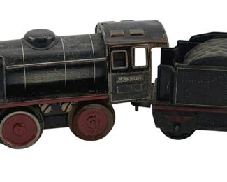 827 - 2x Marklin Locomotive & Coal Car (Description): Vintage Marklin locomotive and coal car set. The black painted tin locomotive features red wheels and red trim details, with 'Marklin' embossed on the cab. The matching coal car displays a simulated coal load. Both pieces show authentic age-related wear to the paint. Measures 3.5" x 10.5" x 2.25".