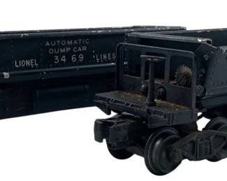 215 - Two Lionel Dumpster Cars 3"x2"x10" (Description): Lionel dumpster cars, also known as automatic dump cars. These model train cars feature the Lionel 3469 Lines marking. Measures 3" x 2" x 10".