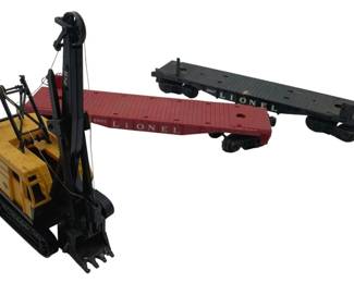 369 - Lionel 2 Flat Train Cars & Backhoe (Description): Group lot of two flat train cars and a backhoe by Lionel. Measures 1 x 11 x 2 inches.
